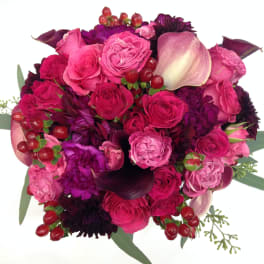 Pink and purple bouquet with roses, calla lilies, and berries