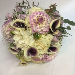 Bouquet of cream, pink, and purple flowers with pearl strands