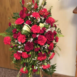 Tall red floral standing spray with roses and carnations