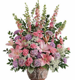 Pink and lavender floral arrangement in a decorative vase
