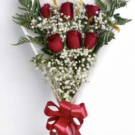 Bouquet of red roses and white baby's breath with a red ribbon