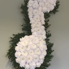 White floral number 7 arrangement with dark green foliage