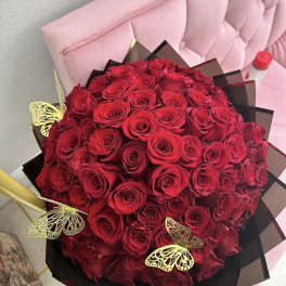 Bouquet of red roses with gold butterfly decorations