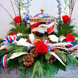 Red roses and patriotic ribbons around an eagle urn centerpiece