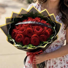 Bouquet of red roses wrapped in black and gold paper
