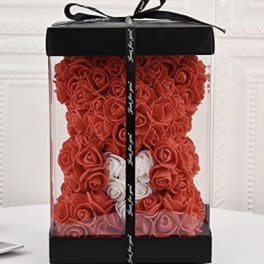 Red rose teddy bear in a clear gift box with a black ribbon