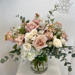 Blush and white rose bouquet in a clear glass vase