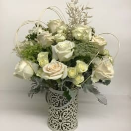 White rose arrangement in a decorative metal vase