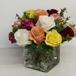 Mixed roses in a square glass vase