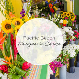 Assorted tropical and mixed flower bouquets in buckets with a "Pacific Beach Designer's Choice" sign