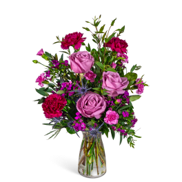 Pink and magenta mixed bouquet in a clear glass vase