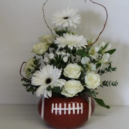 White flowers arranged in a football-shaped vase