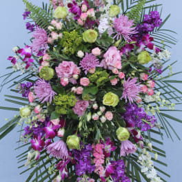 Large standing floral spray with pink, purple, and white flowers