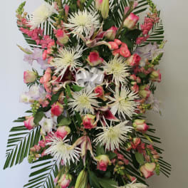 Standing floral spray with pink roses, white spider mums, and lilies