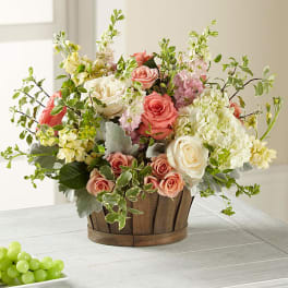 Mixed pink and white roses in a wooden basket