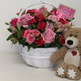 Pink flower basket with a teddy bear and a "It's a GIRL!" sign