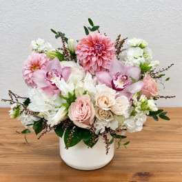 Pink and white floral arrangement in a white vase