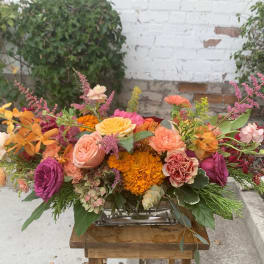 Colorful mixed flower arrangement in a low rectangular vase