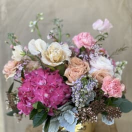 Mixed pink and cream bouquet in a gold vase