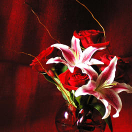 Red roses and white lilies in a glass vase