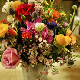 Mixed bouquet of colorful flowers in a metal vase