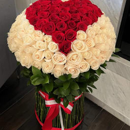 Large bouquet of red and cream roses in a round arrangement