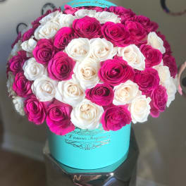 Bouquet of pink and white roses in a turquoise hat box