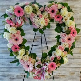 Heart-shaped floral wreath with pink and white roses and gerbera daisies