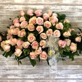 Large bouquet of pale pink roses with a white ribbon bow
