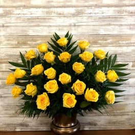 Yellow roses arranged in a bronze vase