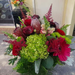 Mixed bouquet with red roses, pink gerbera daisies, and green hydrangea