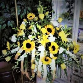 Yellow sunflower arrangement with white flowers and ribbon streamers