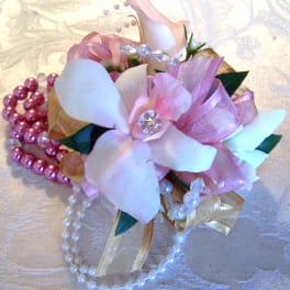 Pink and white floral corsage with pearl beads and ribbon