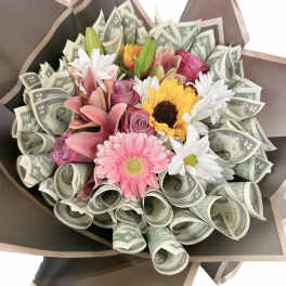 Bouquet of mixed flowers wrapped with rolled dollar bills