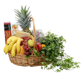 Fruit and snack basket with bananas, grapes, pineapple, cheese, crackers, and potted ivy
