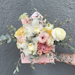 Pastel bouquet in a pink box with white orchids and roses