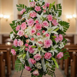 Pink roses and white lilies arranged on a standing easel