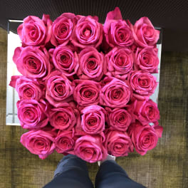 Square box filled with bright pink roses