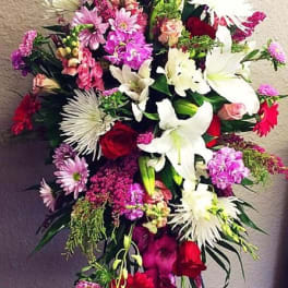 Tall standing floral spray with lilies, roses, and pink mixed blooms