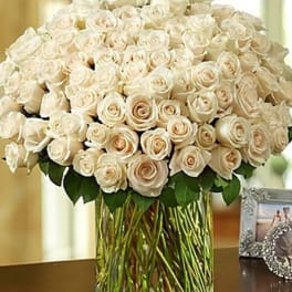 Large bouquet of cream roses in a clear glass vase