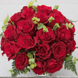 Bouquet of red roses with small green accents