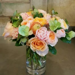 Peach and blush bouquet in a clear glass vase