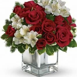 Red roses and white alstroemeria in a clear square vase