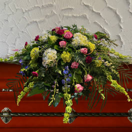 Large floral casket spray with pink roses and mixed blooms