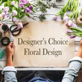 Designer’s Choice Floral Design sign surrounded by tulips and floral tools