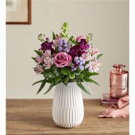 Pink and purple mixed bouquet in a white vase