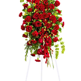 Tall red rose and carnation standing spray on a white easel