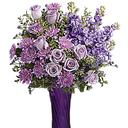 Lavender roses and purple flowers in a tall vase