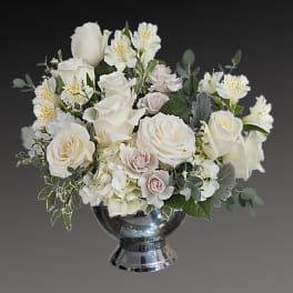 White rose arrangement in a silver vase