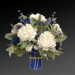 Blue and white floral arrangement in a cobalt vase